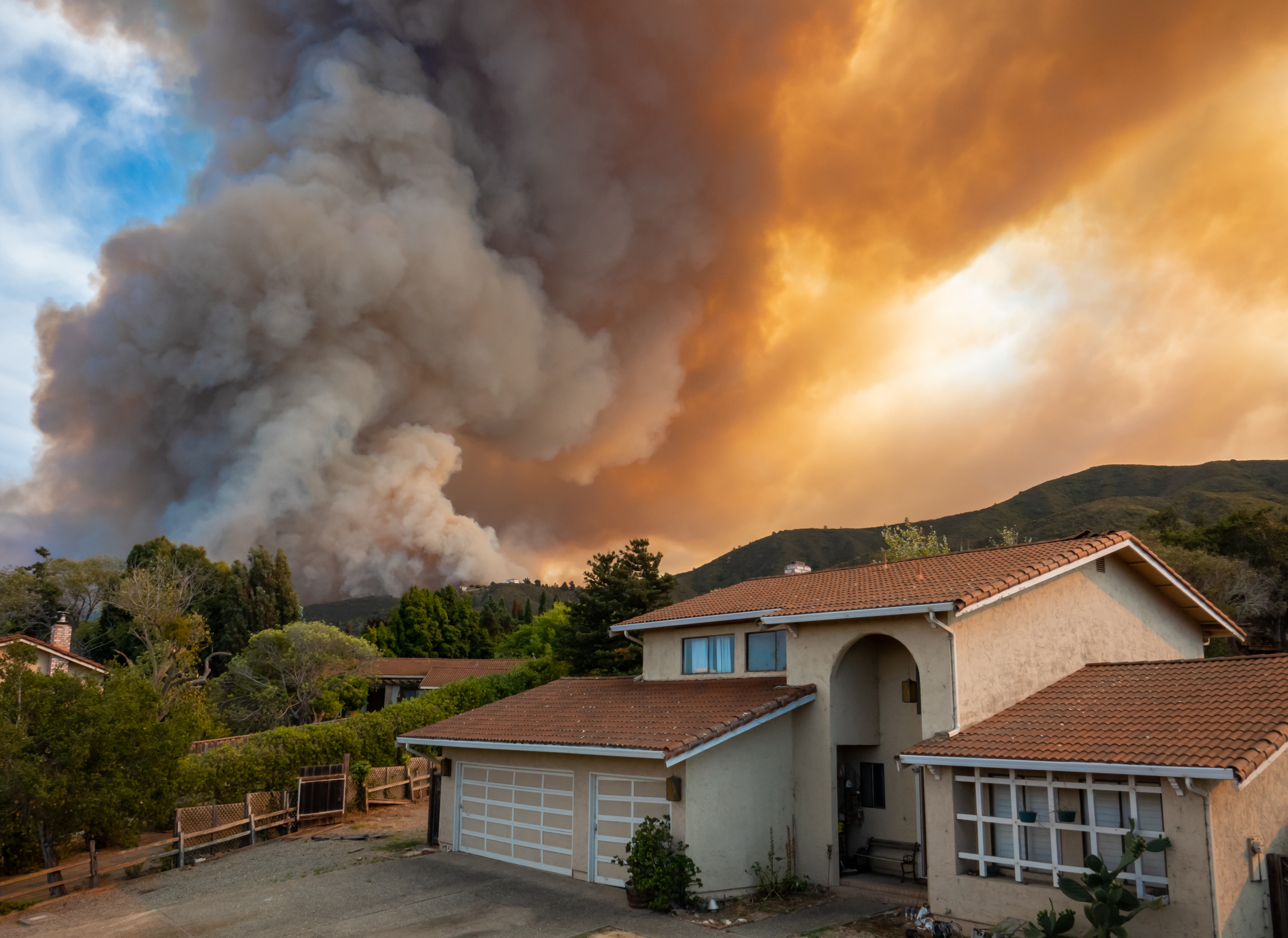 Wildfire smoke is seen from the suburb neighbourhood