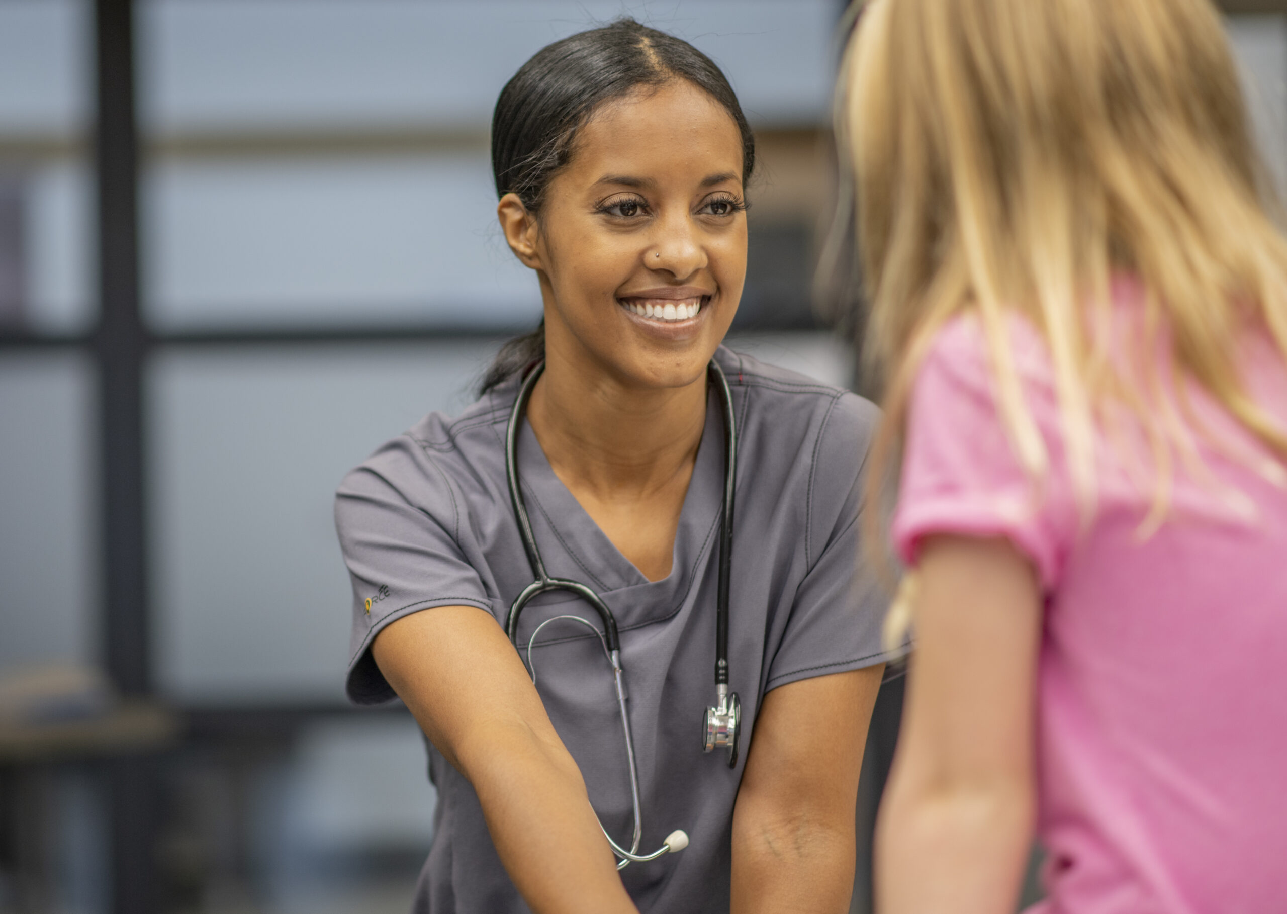 School nurse talking to a child.