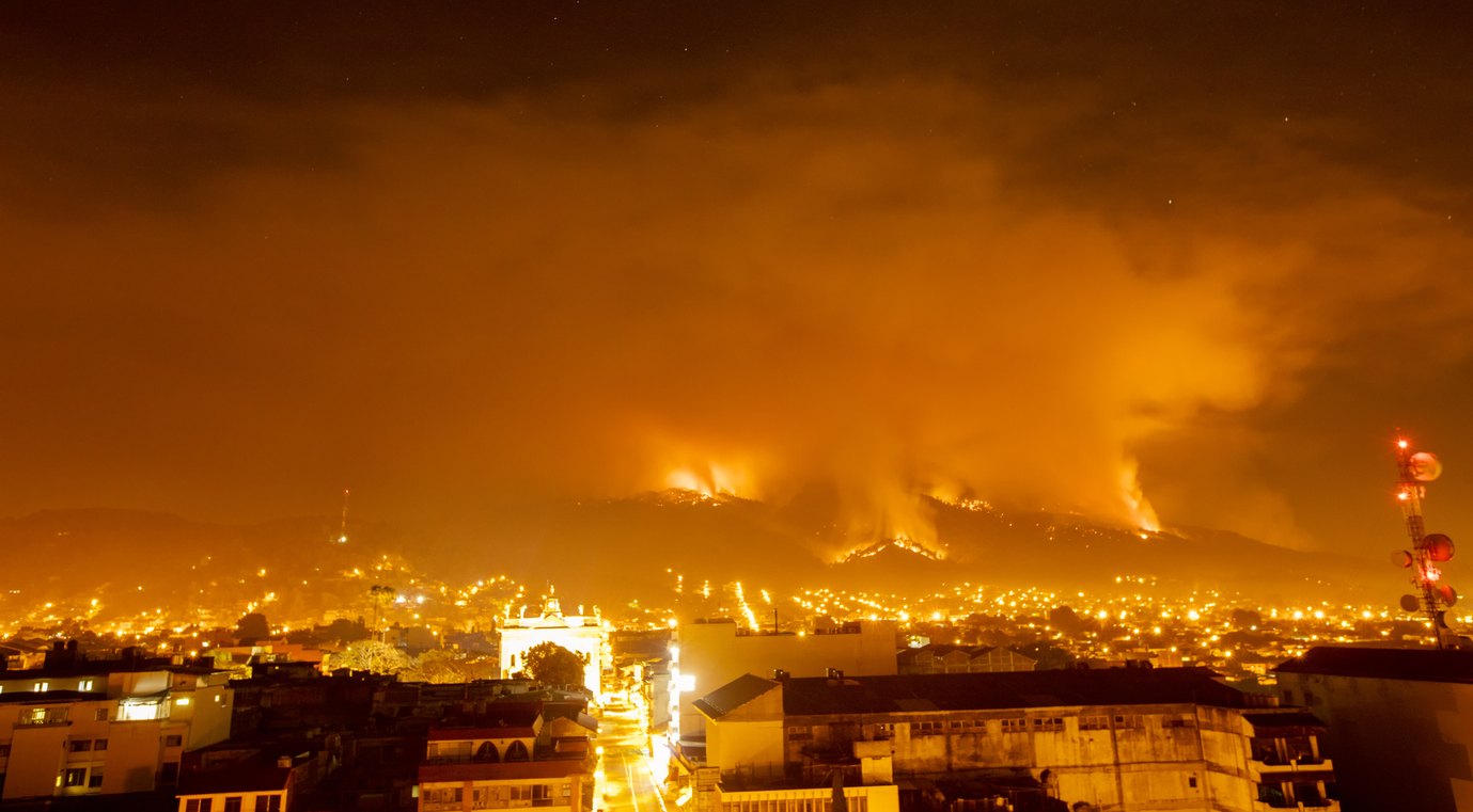 photographs taken of a mountain fire in a city, which means more pollution by climate change