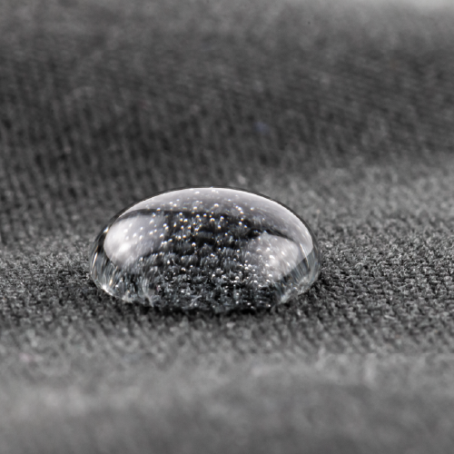 Image of a water droplet on a woven textile.