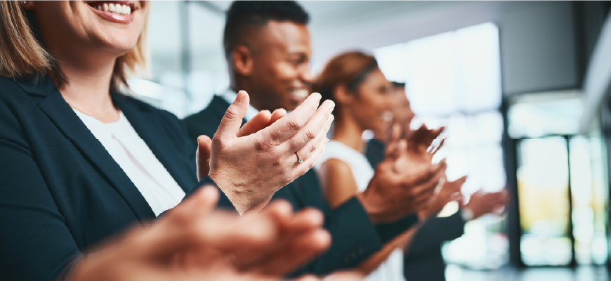 Professionals clapping to congratulate someone on an award.