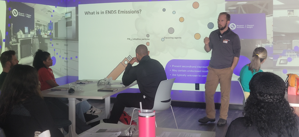 An education and training specialist facilitates a discussion with educators.