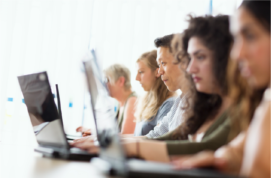 Graduate students learning at pc